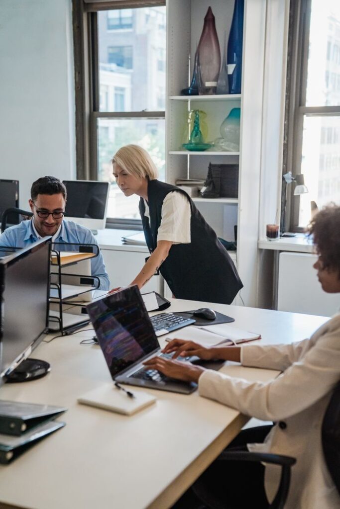 The Art of Drawing Readers In: Your attractive post title goes here Professionals working collaboratively in a contemporary office environment with laptops and documents.