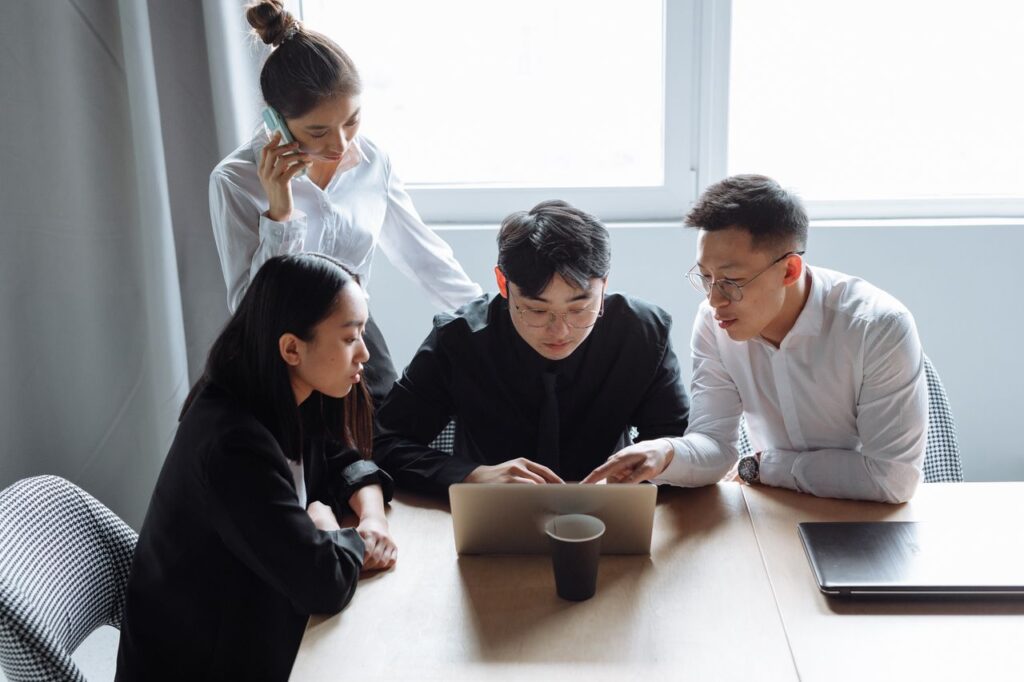Mastering the First Impression: Your intriguing post title goes here Business team brainstorming in an office setting with laptops and teamwork spirit.