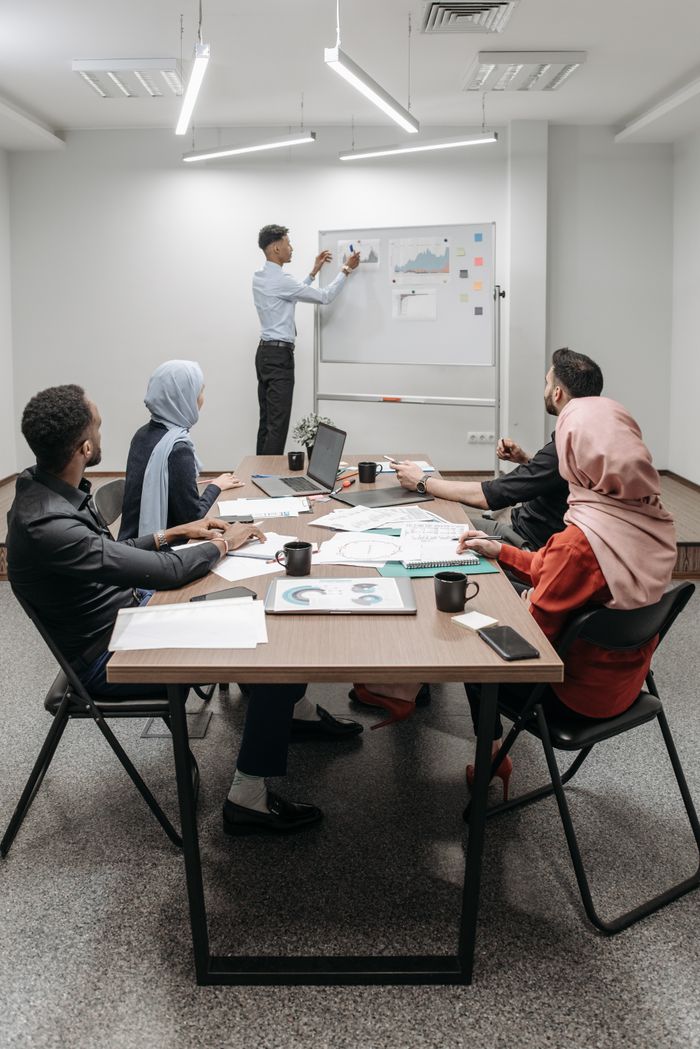Services Business meeting with diverse team discussing ideas in modern office.